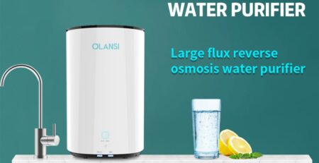 Reverse osmosis water purifier with filter status indicator next to a kitchen faucet and glass of water